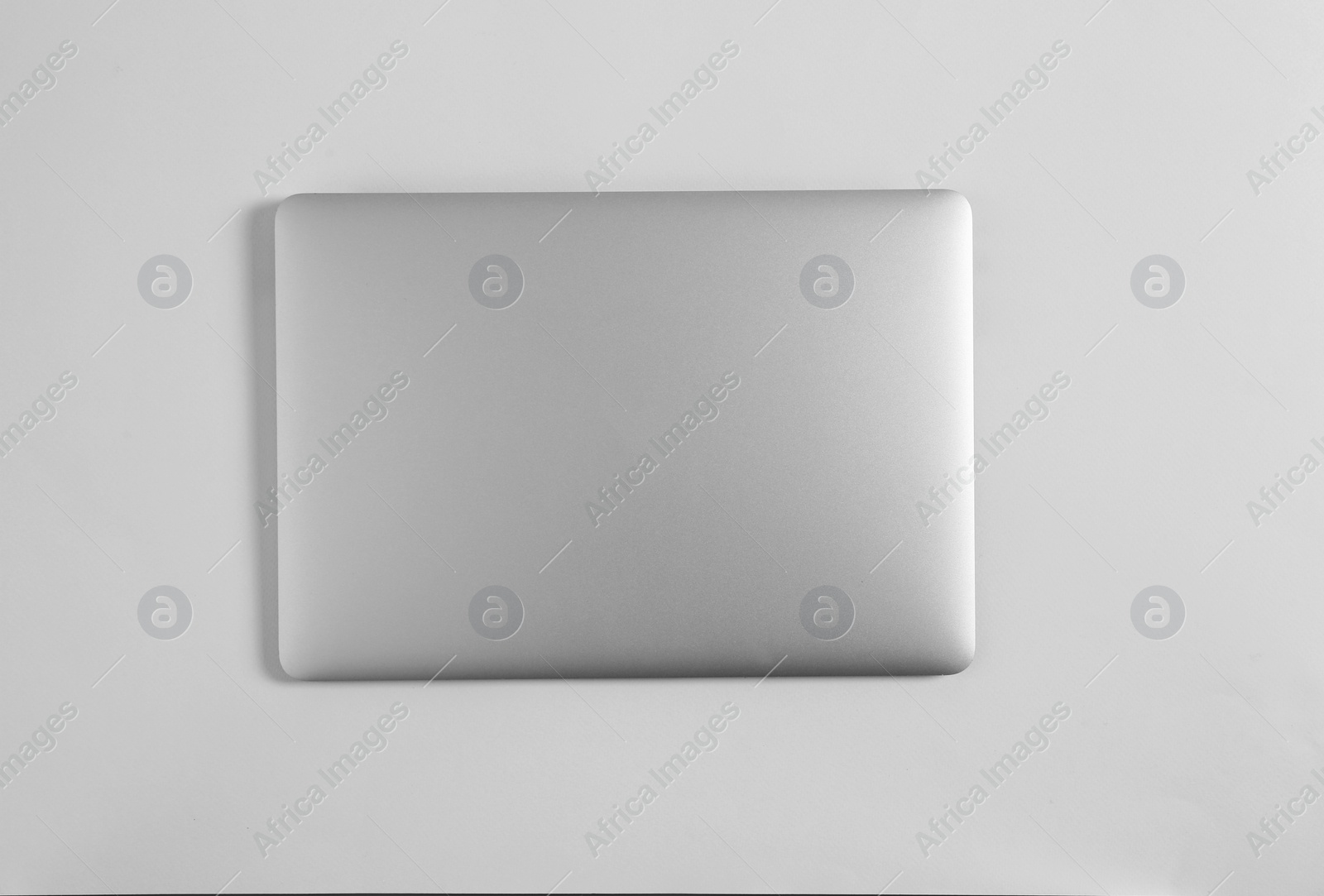 Photo of Modern laptop on light background, top view