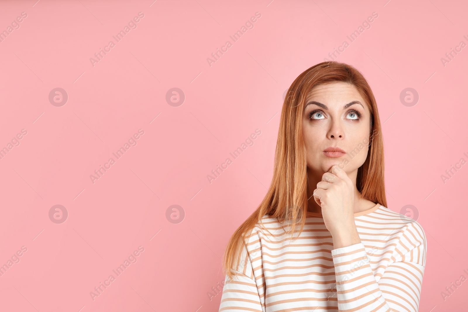 Photo of Pensive woman on pink background, space for text. Thinking about answer to question