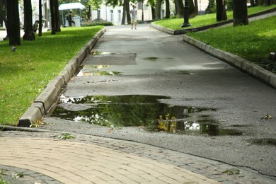 Puddle of rain water on pathway outdoors