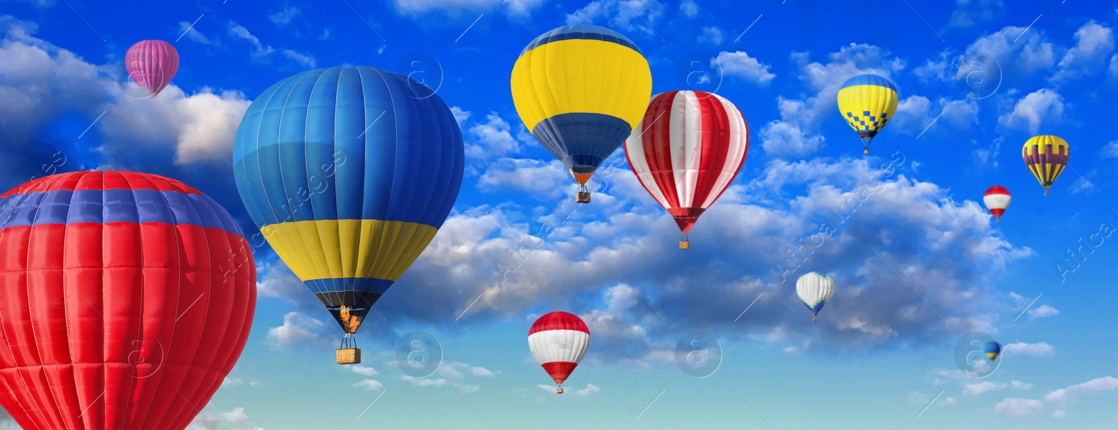 Image of Many bright hot air balloons flying in sky, banner design