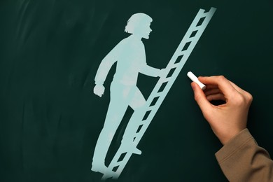 Woman drawing person climbing up ladder on chalkboard, closeup. Steps to success