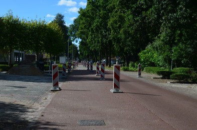 Striped road warning posts on city street
