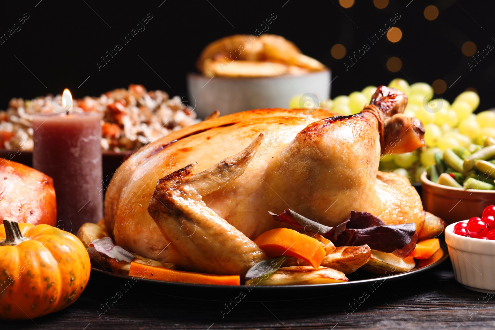 Photo of Traditional Thanksgiving day feast with delicious cooked turkey and other seasonal dishes served on table, closeup