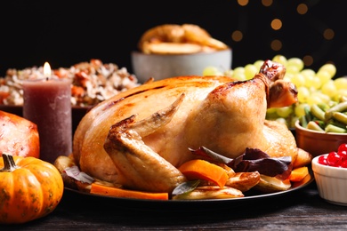 Traditional Thanksgiving day feast with delicious cooked turkey and other seasonal dishes served on table, closeup