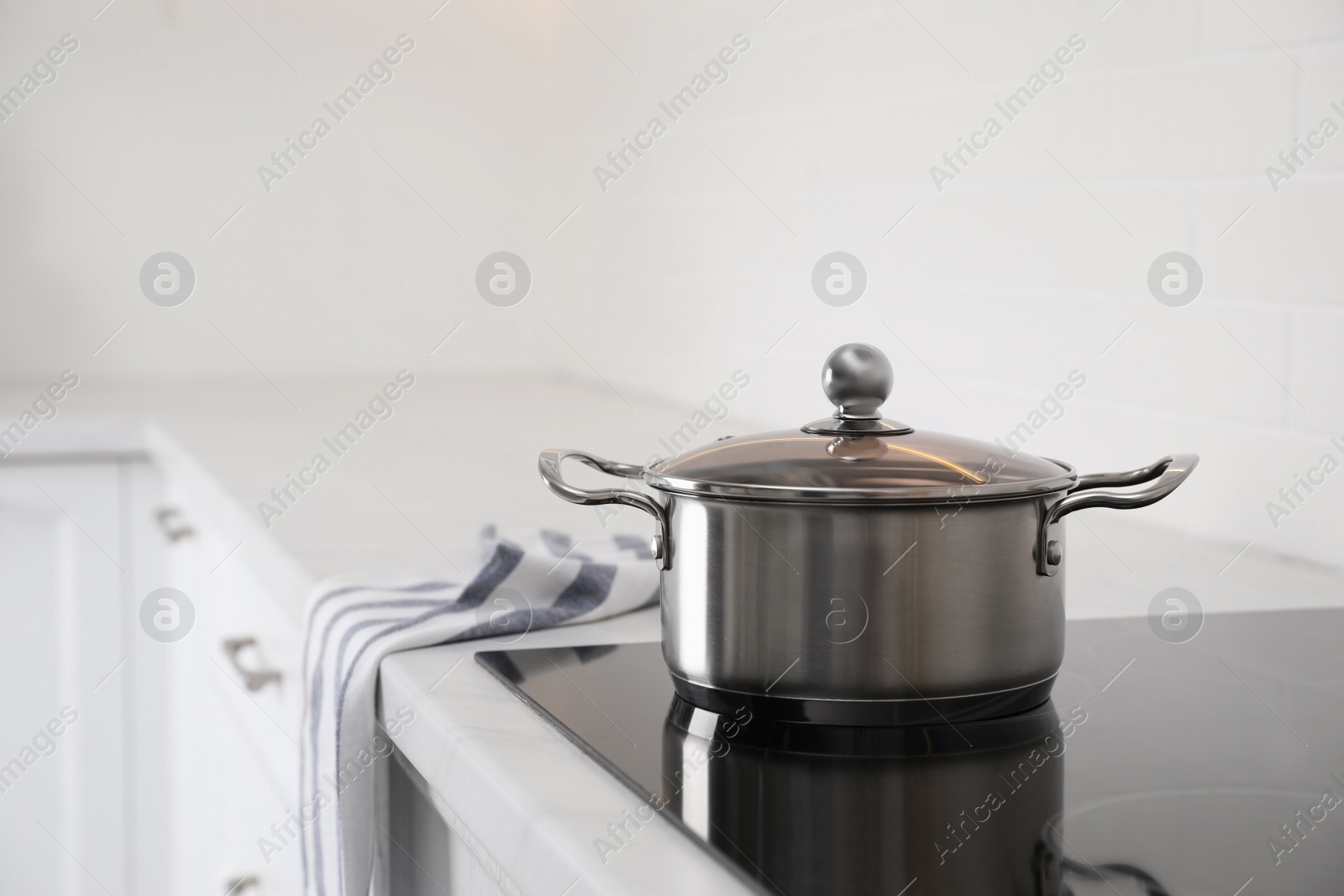 Photo of New clean pot on cooktop in kitchen, space for text