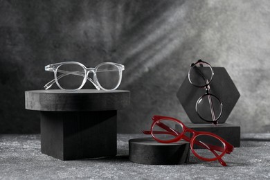 Photo of Stylish presentation of glasses on grey background