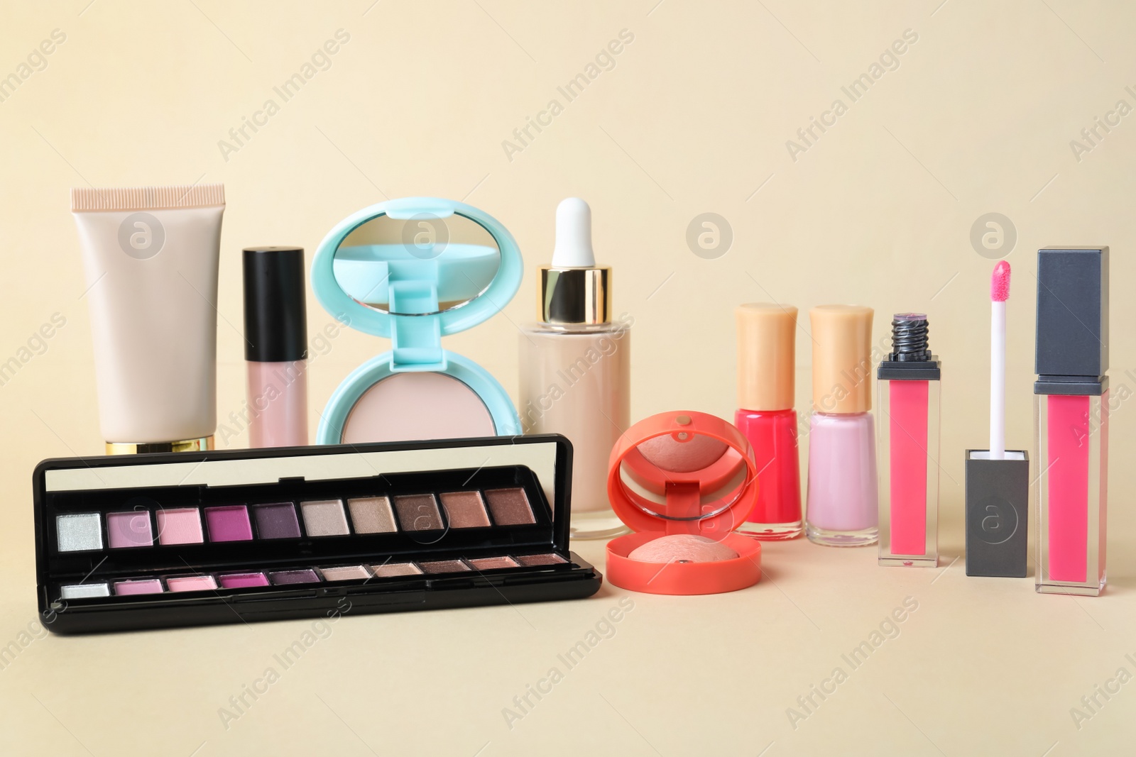 Photo of Different luxury decorative cosmetics on beige background