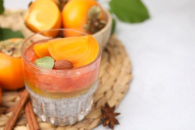 Photo of Delicious dessert with persimmon and chia seeds on table. Space for text