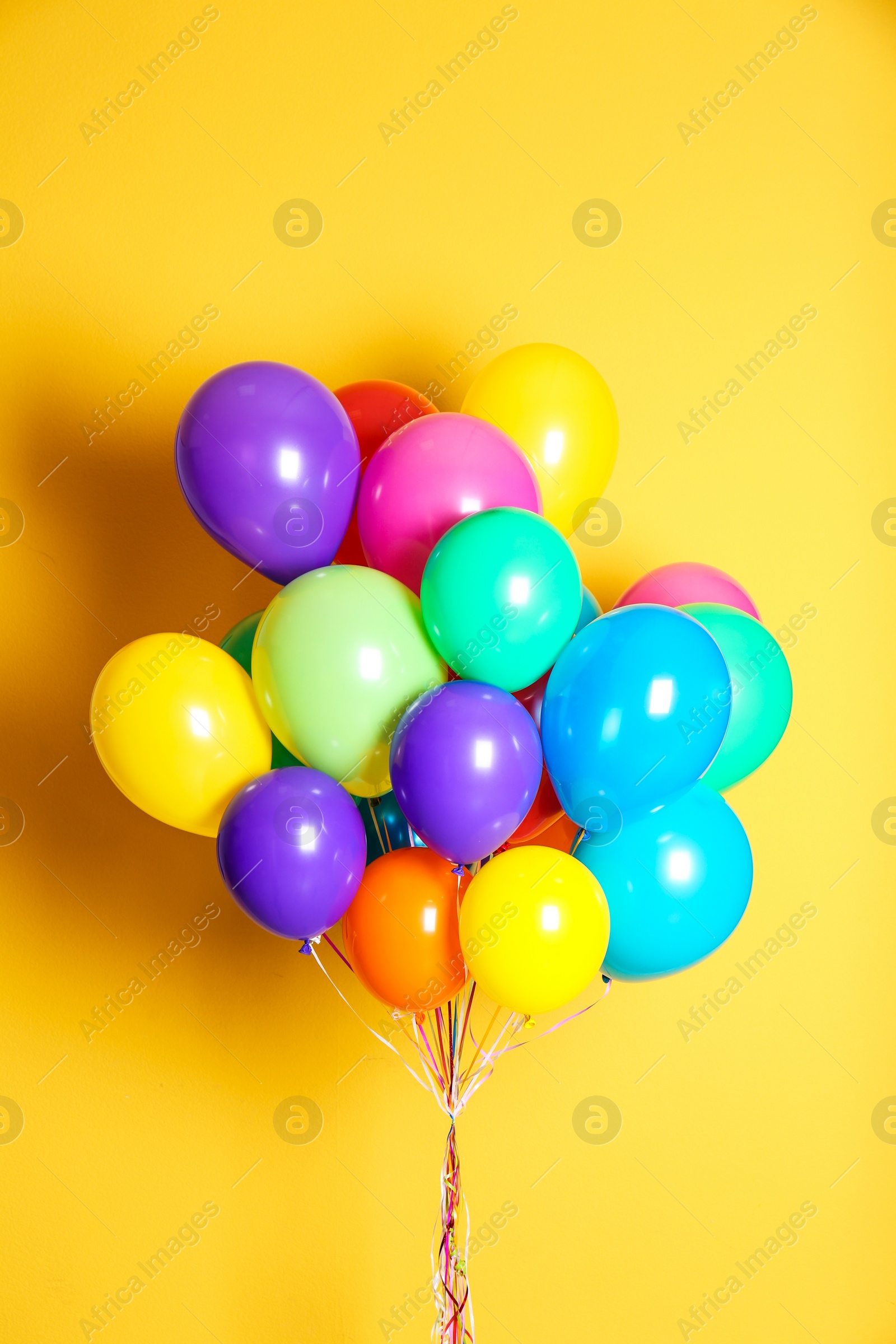 Photo of Bunch of bright balloons on color background. Festive decor