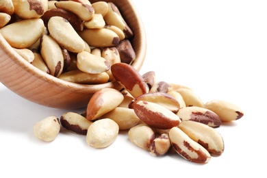 Wooden bowl with Brazil nuts on white background