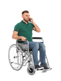 Photo of Young man in wheelchair talking by mobile phone isolated on white