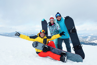 Photo of Group of friends with equipment in snowy mountains. Winter vacation