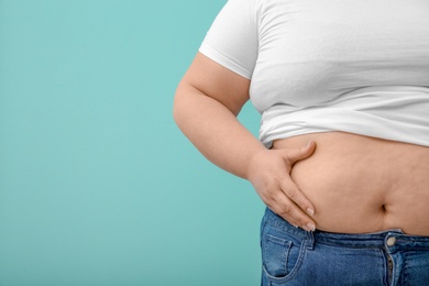 Photo of Overweight woman on color background