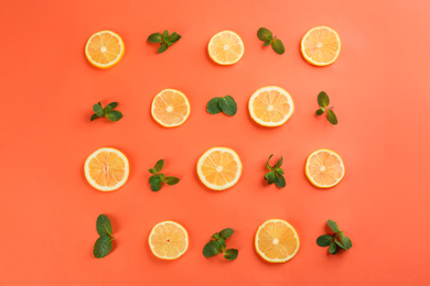 Photo of Lemonade layout with juicy lemon slices and mint on coral background, top view