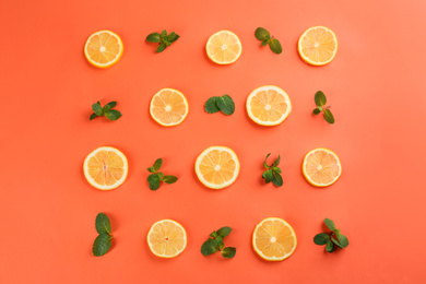 Lemonade layout with juicy lemon slices and mint on coral background, top view