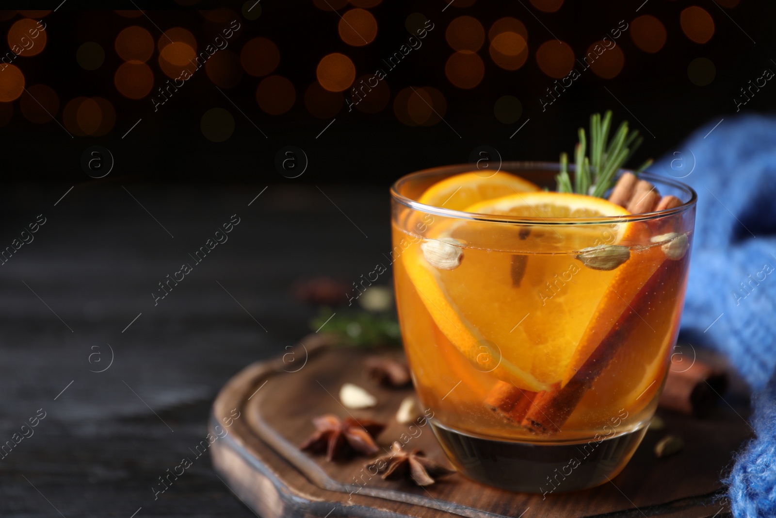 Photo of Aromatic mulled wine on wooden board. Space for text