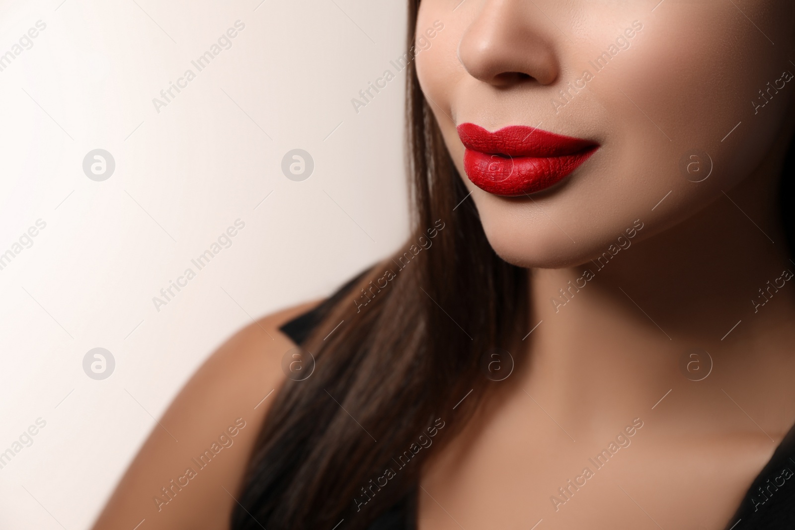 Photo of Beautiful woman with red lipstick on light background, closeup
