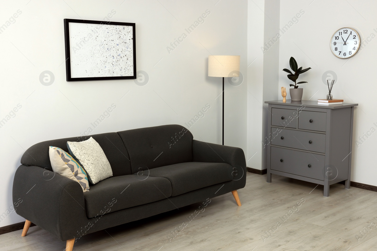 Photo of Stylish room interior with sofa and other furniture