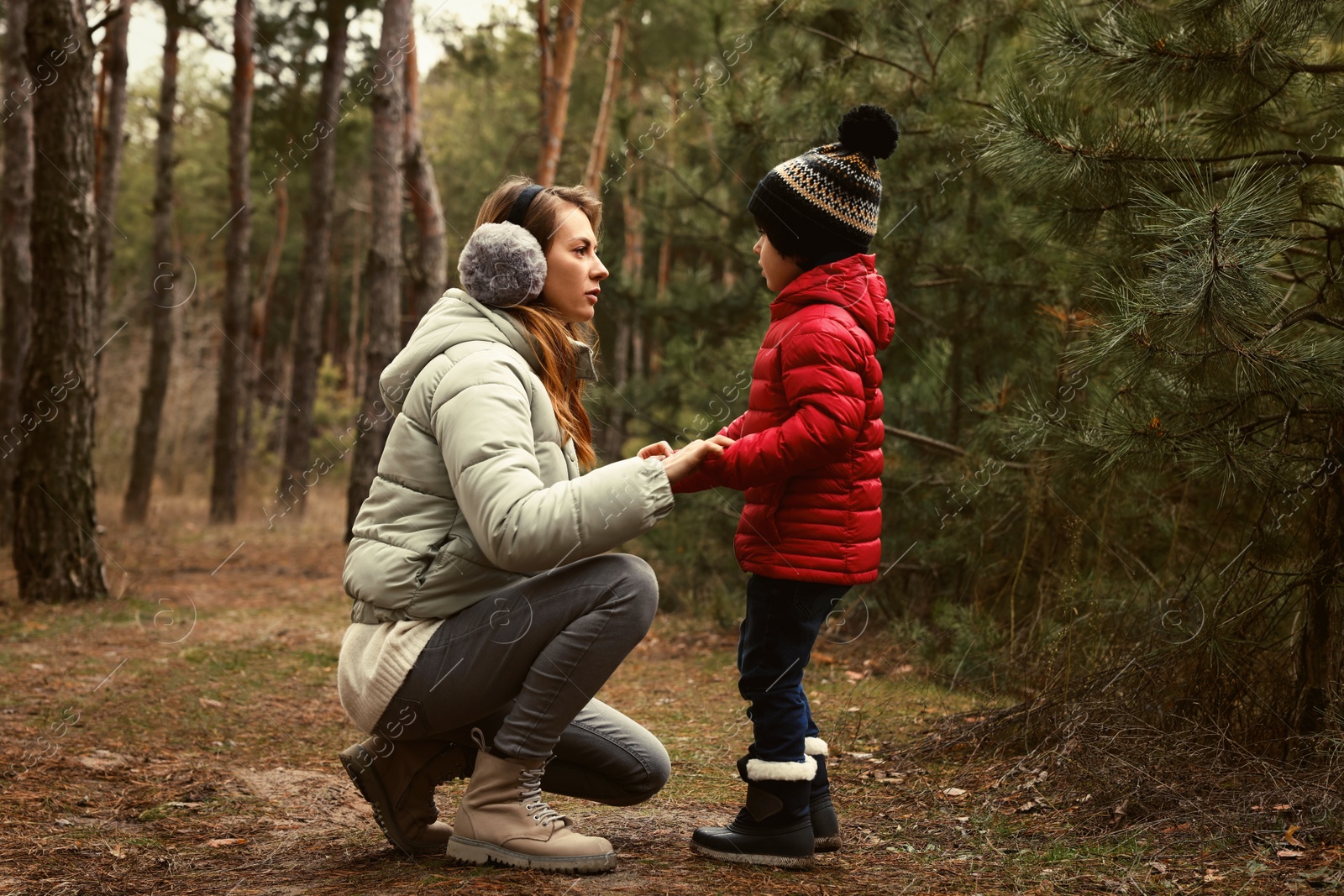 Photo of Woman and her son spending time together in forest