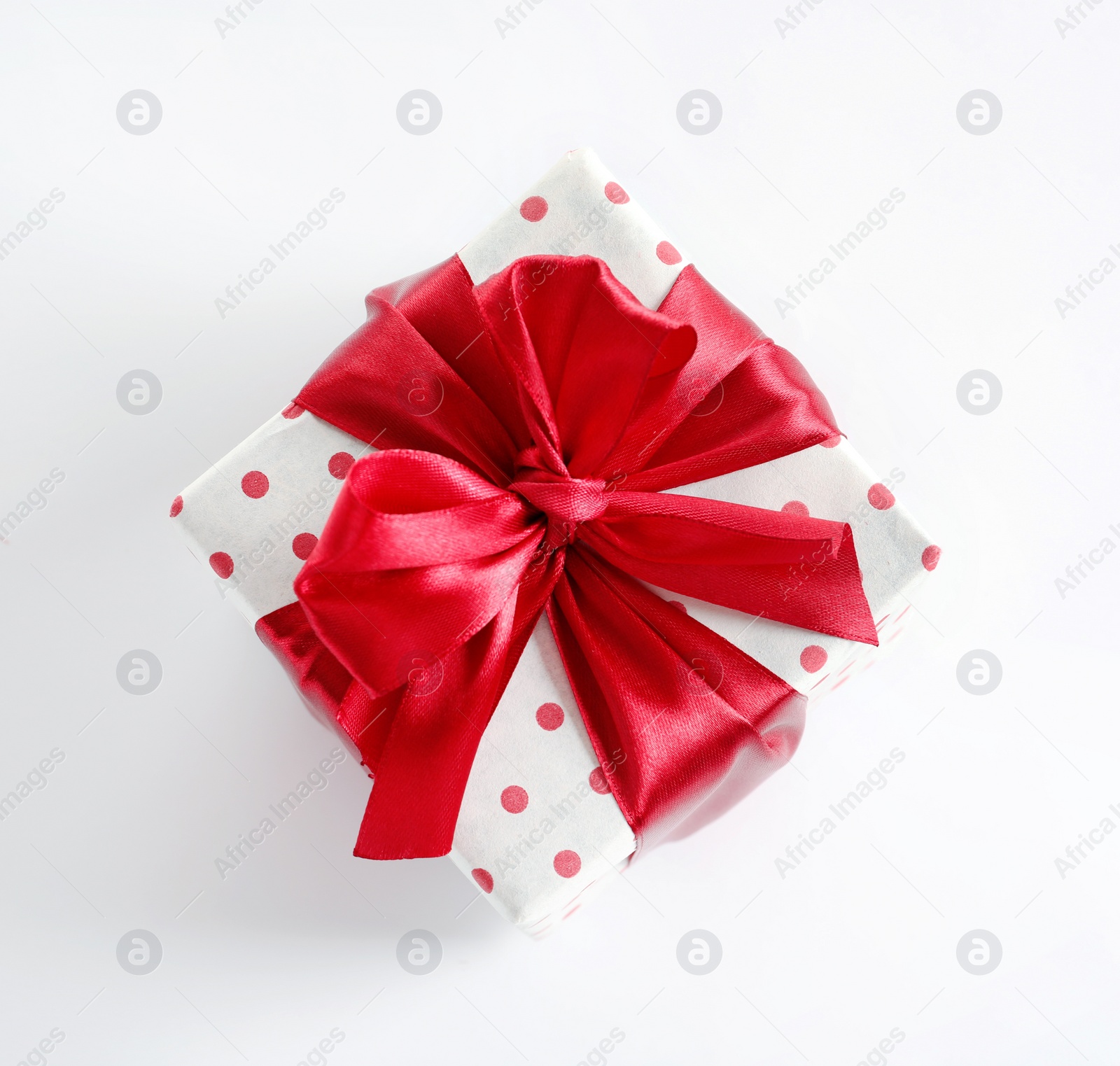 Photo of Beautifully wrapped gift box on white background, top view