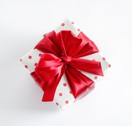 Beautifully wrapped gift box on white background, top view