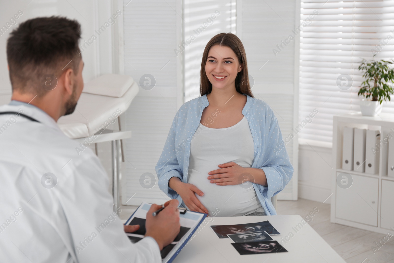 Photo of Pregnant woman having appointment at gynecologist office