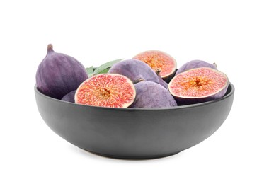 Whole and cut fresh purple figs in bowl isolated on white