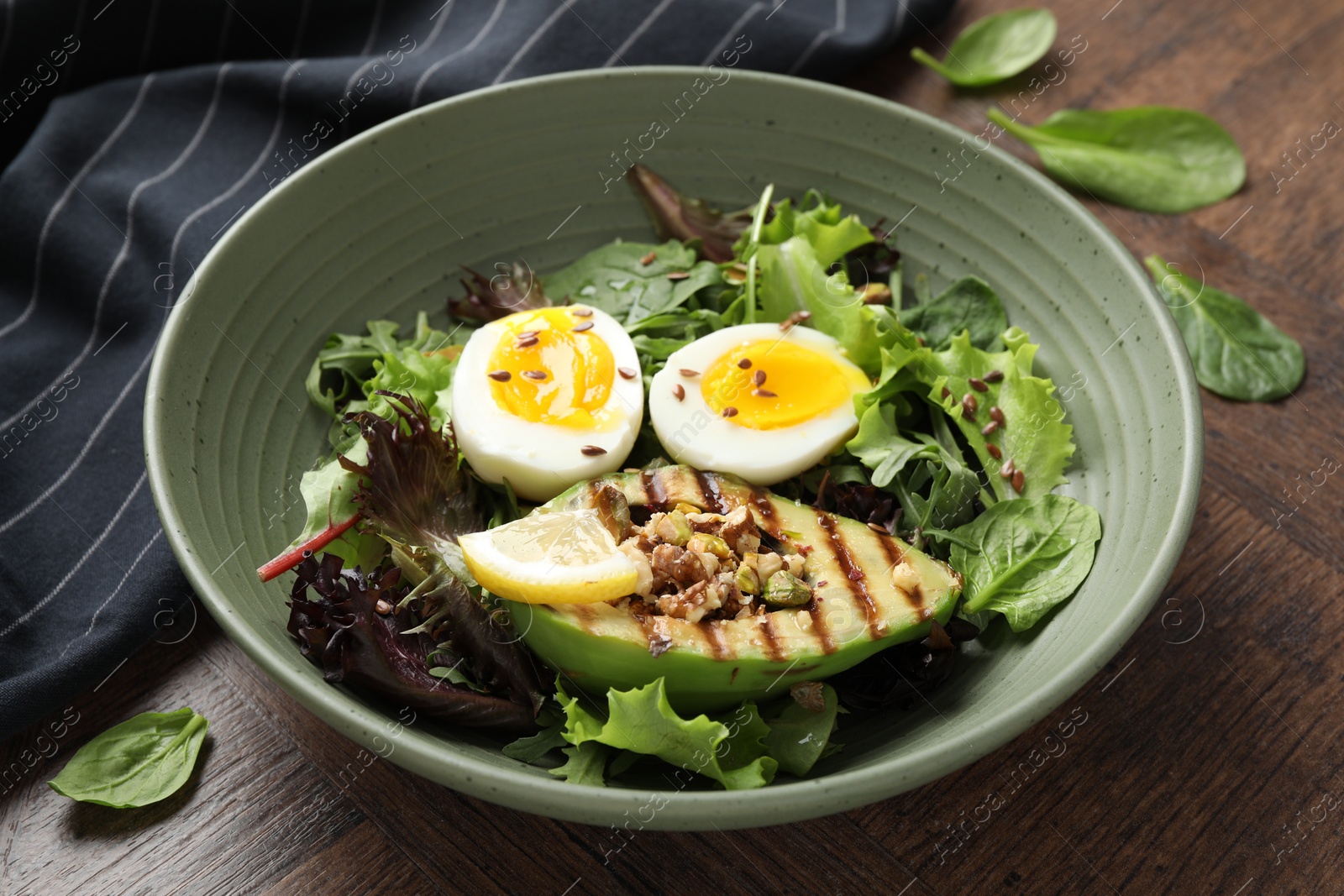 Photo of Healthy dish high in vegetable fats on wooden table, closeup