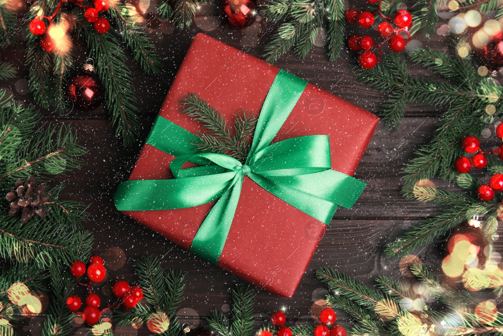 Image of Flat lay composition with red Christmas gift box on wooden table