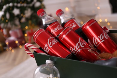 Photo of MYKOLAIV, UKRAINE - JANUARY 13, 2021: Coca-Cola bottles and cans in box, closeup