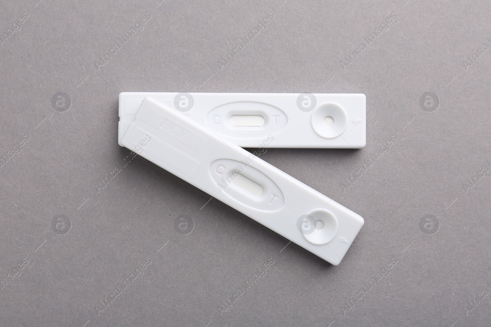 Photo of Disposable express tests on light grey background, top view