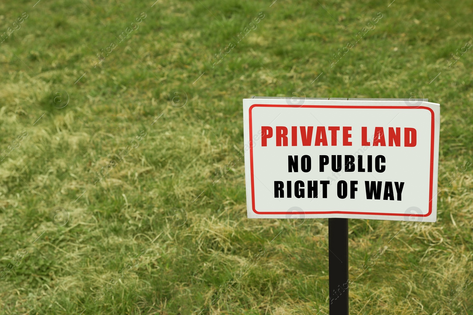 Image of Sign with text Private Land No Public Right Of Way on green lawn