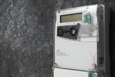 Photo of Electricity meter on grey wall, space for text