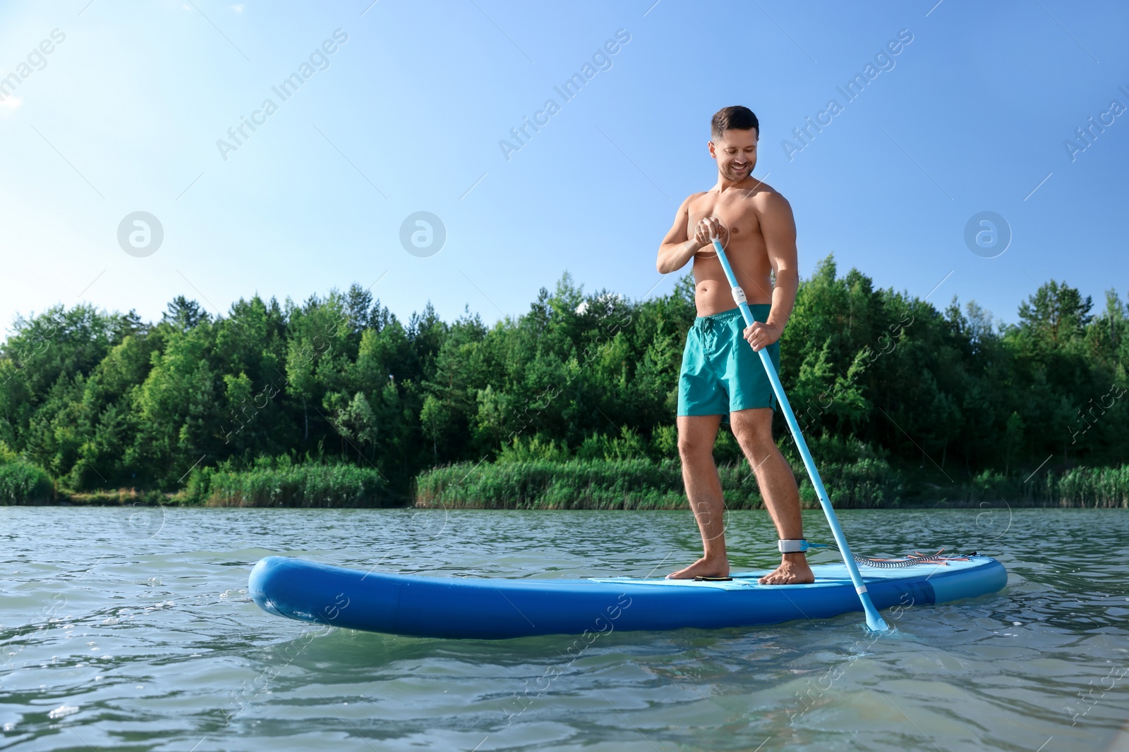 Photo of Man paddle boarding on SUP board in river