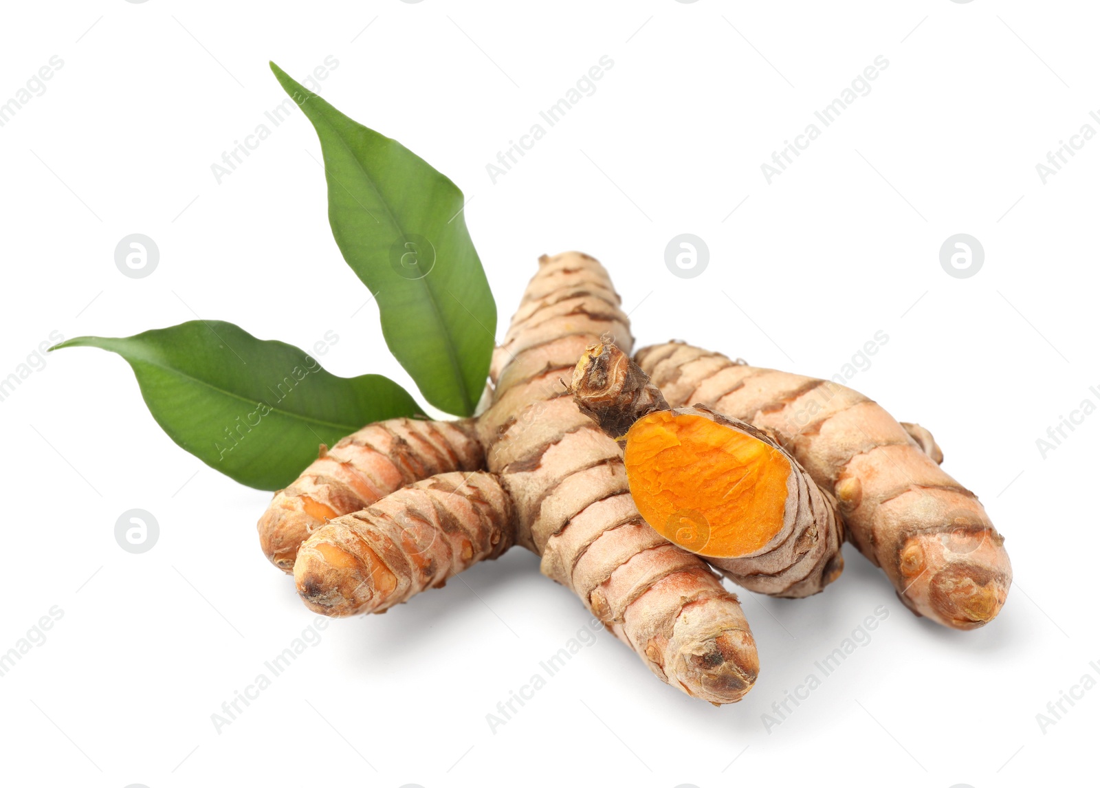 Photo of Fresh turmeric roots and green leaves isolated on white