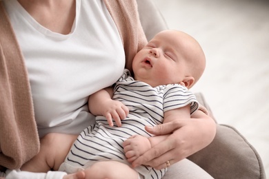 Mother with her sleeping baby at home