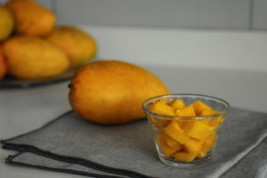 Delicious cut and whole mangoes on light table