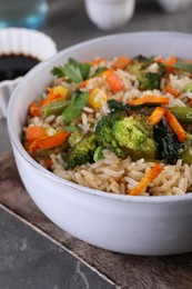 Tasty fried rice with vegetables on grey table, closeup
