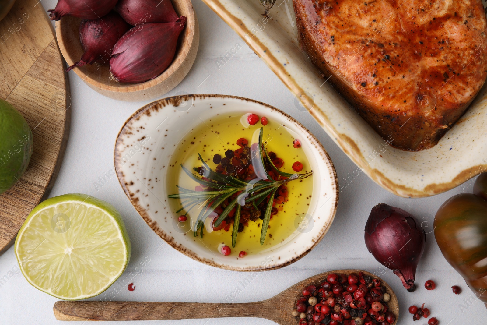 Photo of Fresh marinade, cooked fish and other products on white tiled table, flat lay