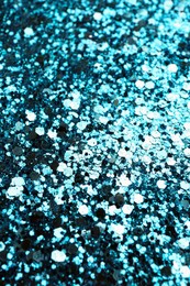 Photo of Shiny bright light blue glitter as background, closeup