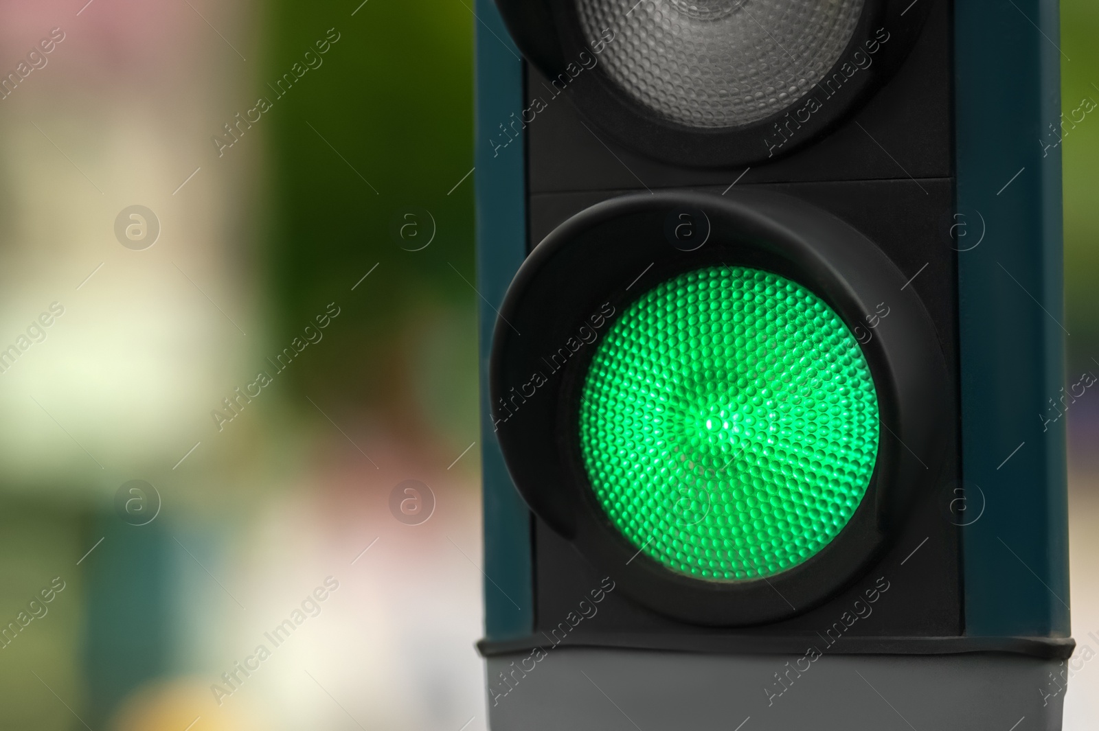 Photo of Traffic light on blurred background, closeup. Space for text