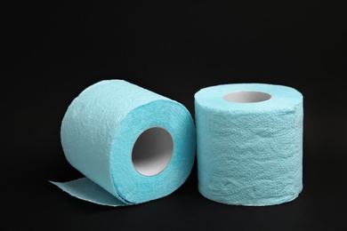 Photo of Toilet paper rolls on black background. Personal hygiene