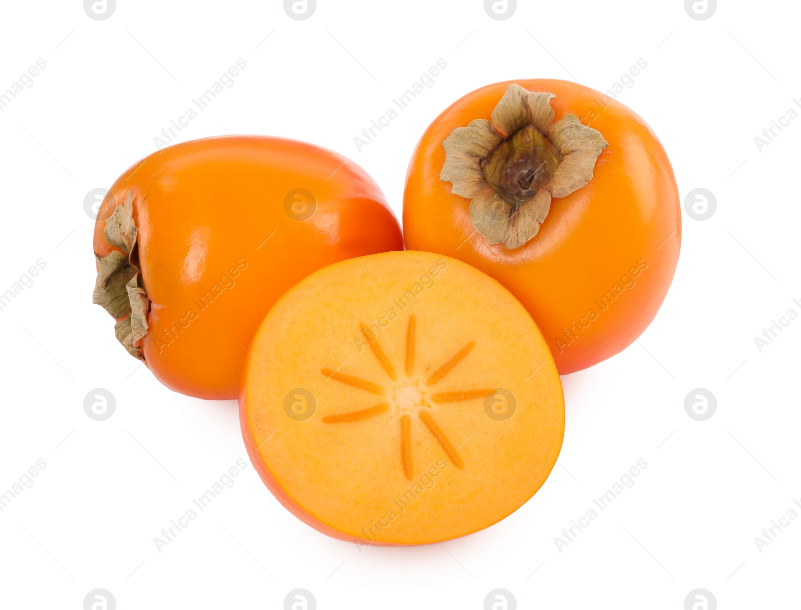 Photo of Whole and cut persimmon fruits isolated on white