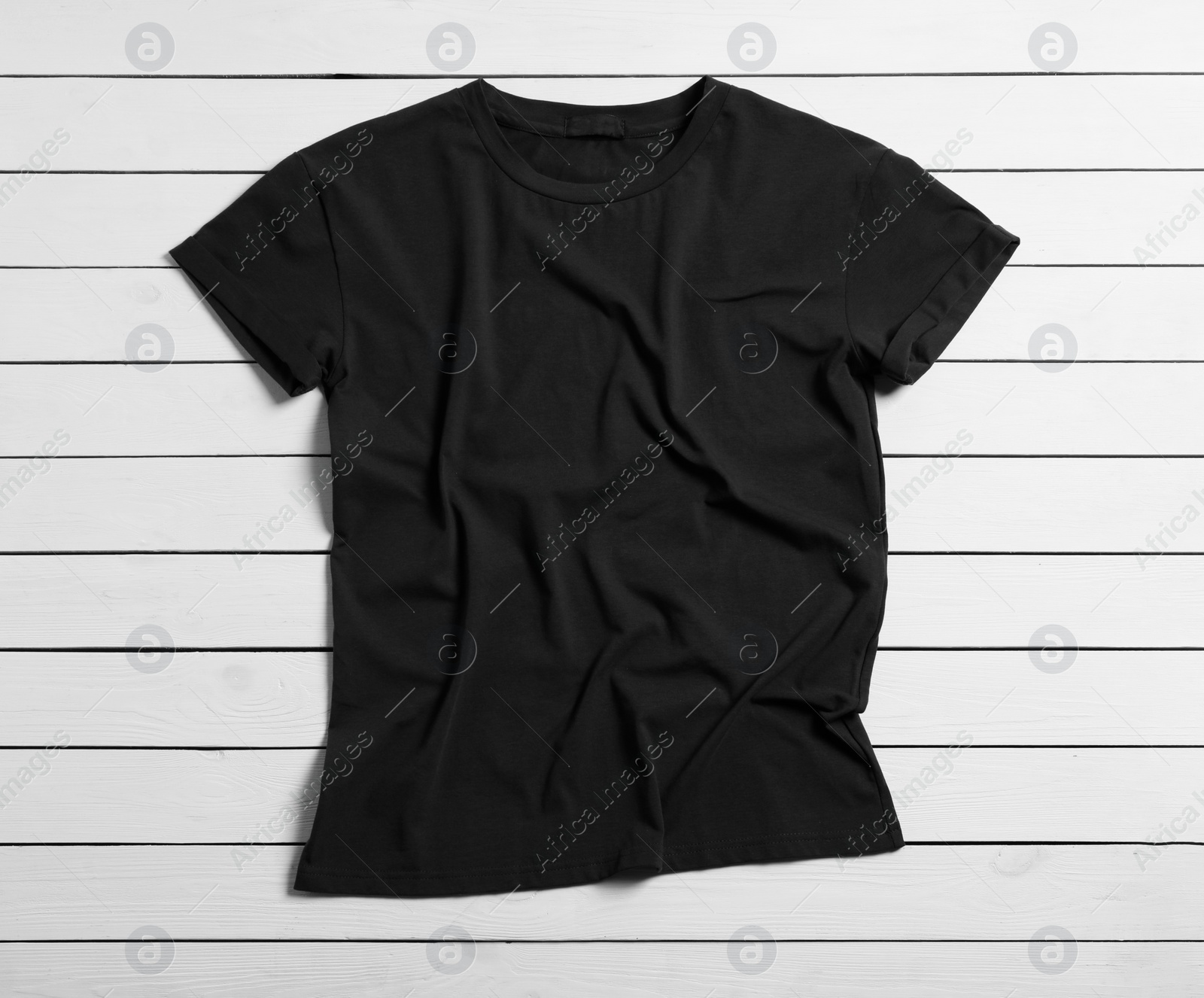 Photo of Stylish black t-shirt on white wooden background, top view