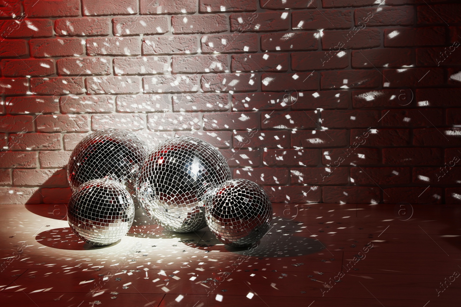Photo of Many shiny disco balls in dark room. Space for text