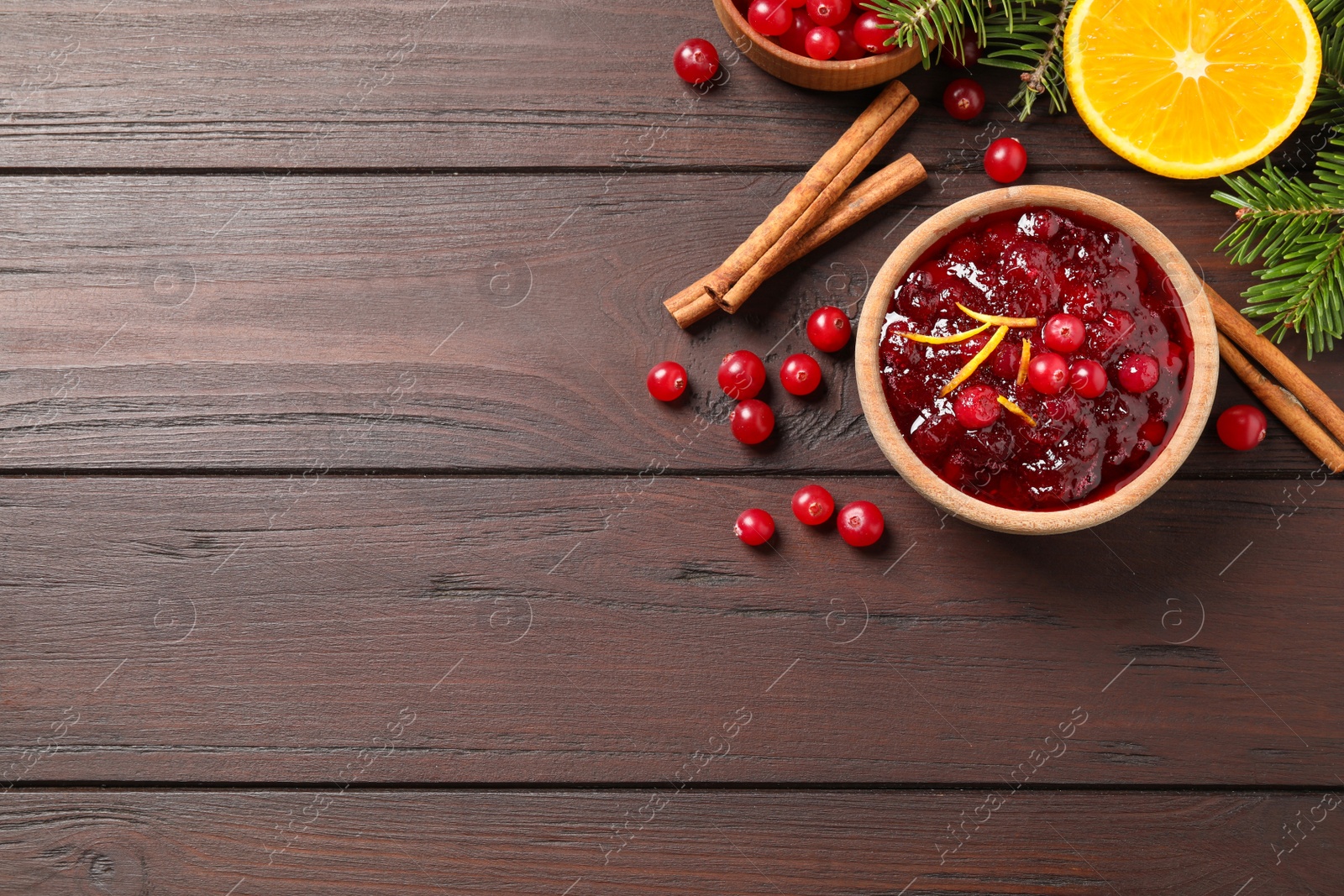 Photo of Flat lay composition with cranberry sauce on wooden table, space for text