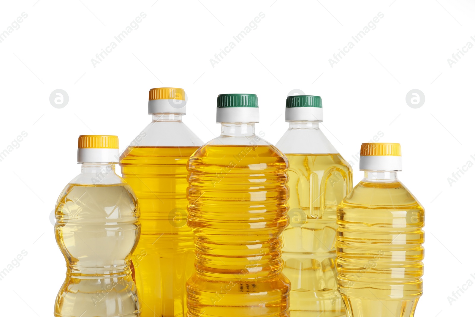 Photo of Bottles of cooking oil on white background