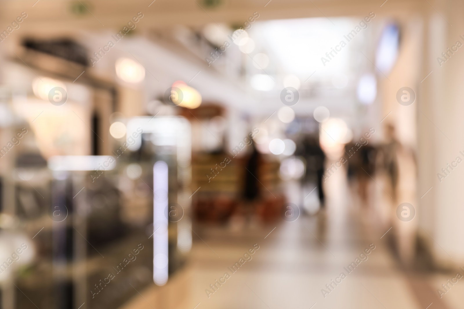 Photo of Blurred view of modern shopping mall interior. Bokeh effect