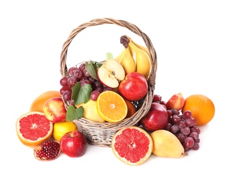 Photo of Wicker basket with different fruits on white background