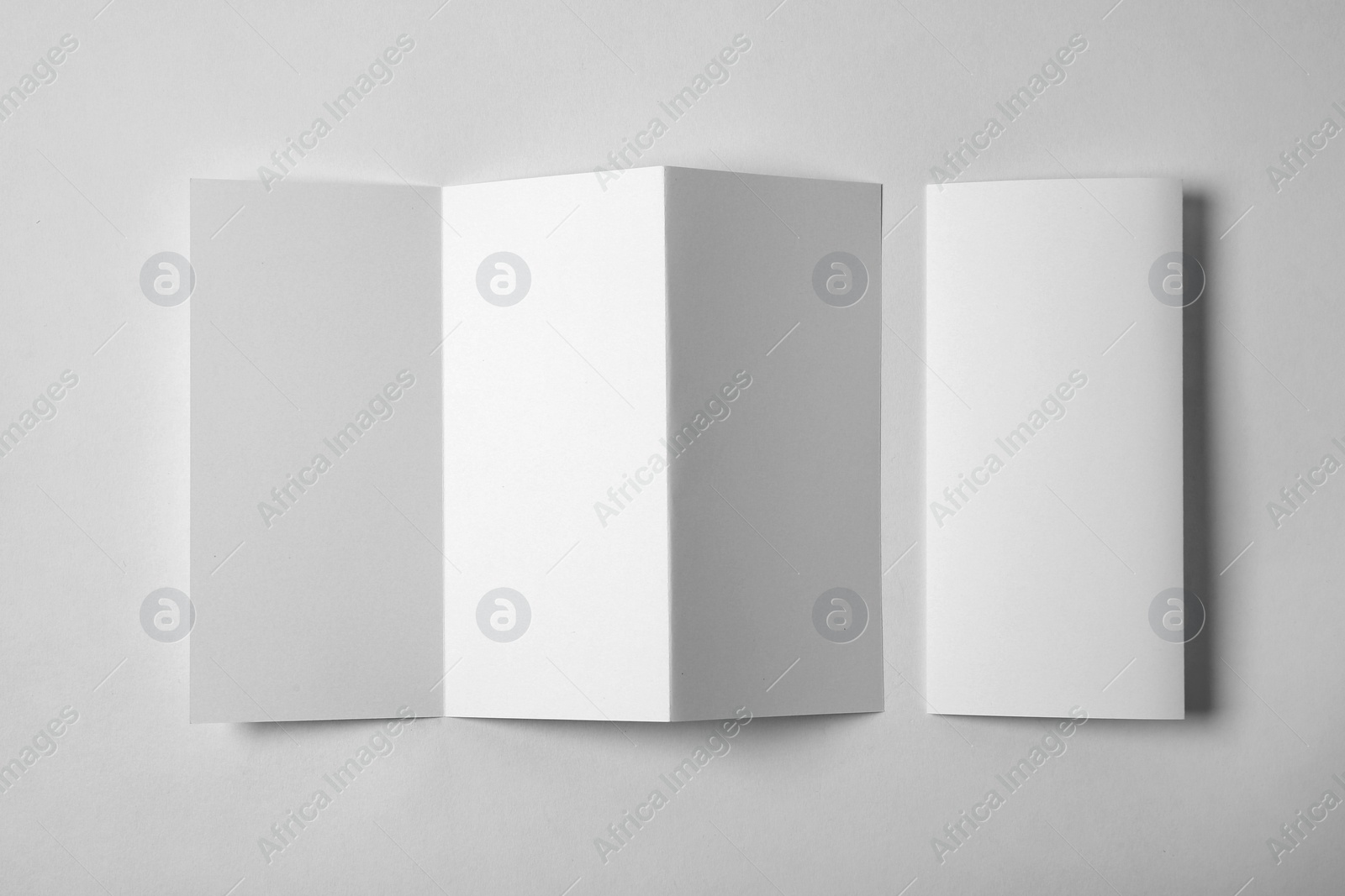 Photo of Blank brochure on white background, above view. Mock up for design